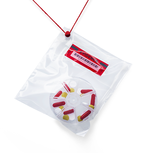Plastic evidence bag with red pills inside 